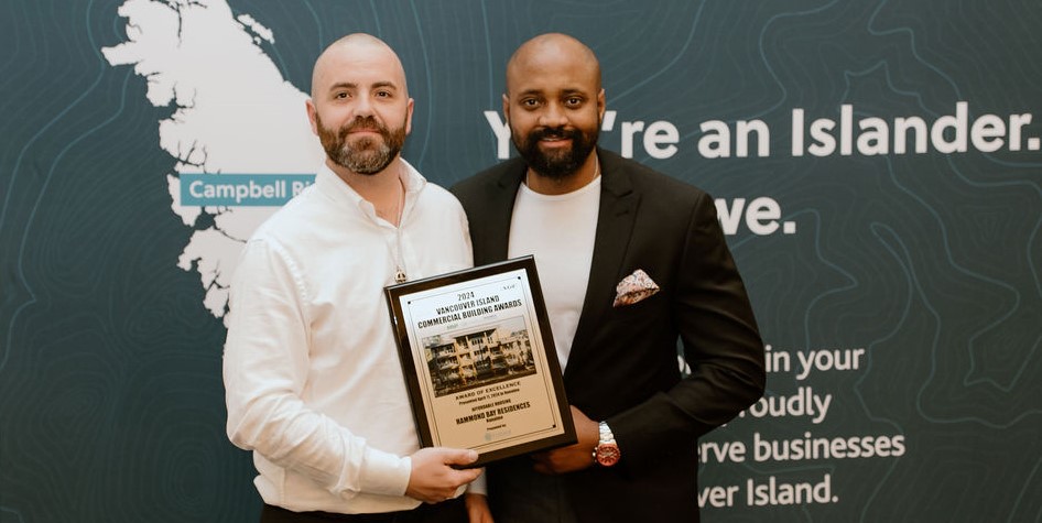 Left, Klye Leslie with Westmark Construction, and right, a representative from Ballenas Housing Society, holding the VIREB Excellence Award for Affordable Housing in Nanaimo, BC.