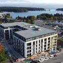 Drone photo of the 340 Campbell Street mixed-use development in downtown Nanaimo, showing exterior siding nearing completion and its proximity to the waterfront.