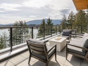 Outdoor terrace at Link on Long Lake in Nanaimo, featuring lounge seating and views over Long Lake and the surrounding landscape.