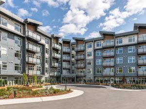 Exterior of Melody in Nanaimo, a five-storey multi-family rental development with landscaped grounds and private balconies.