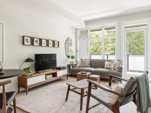 Interior of a modern rental apartment at Melody in Nanaimo, featuring a bright living room, balcony and contemporary finishes.