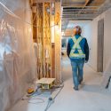 Westmark construction worker walking through the interior of a multi-family building under construction on Vancouver Island.